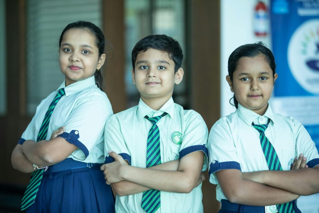 pexels-photo-30889597-30889597 Three Indian school students posing confidently in uniform indoors.